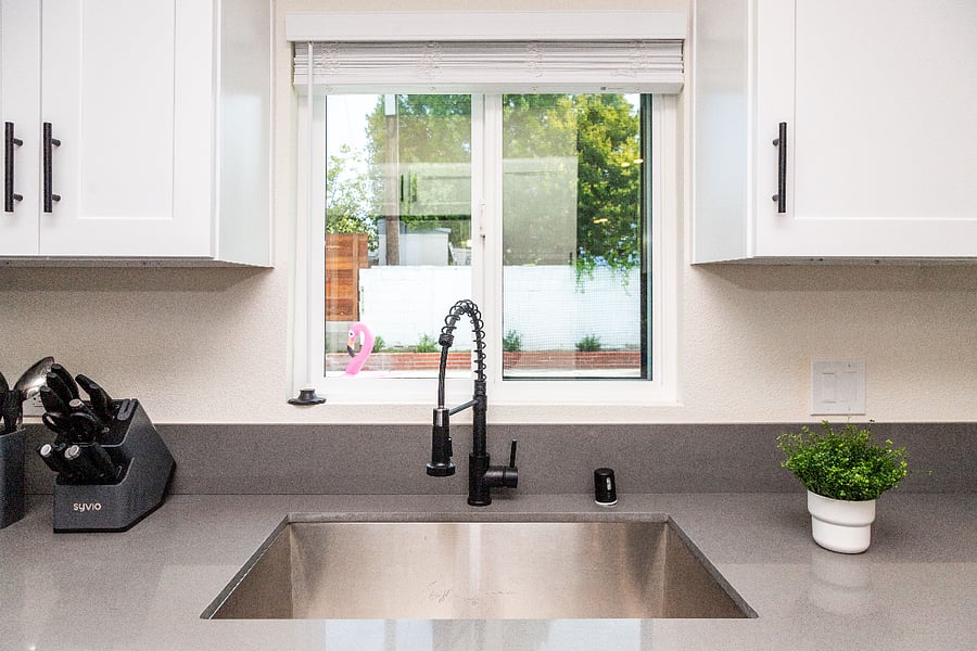 Modern kitchen sink with backyard view