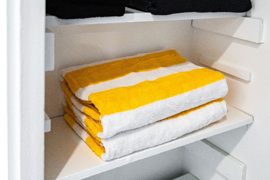 Linen storage with fresh towels for move-in ready stay