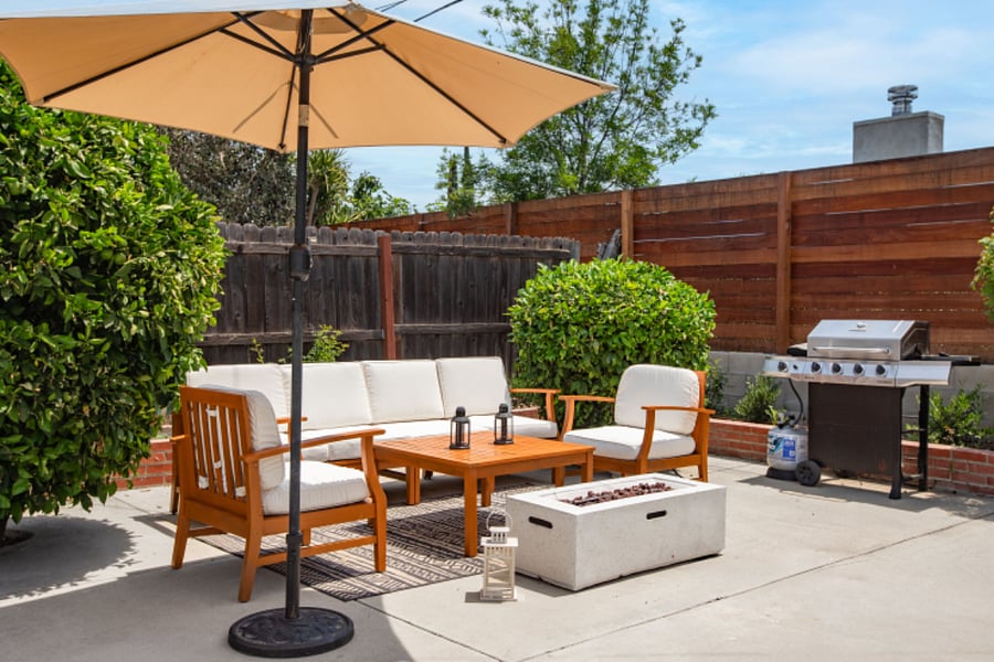 Private backyard seating with BBQ and fire pit for long-term comfort