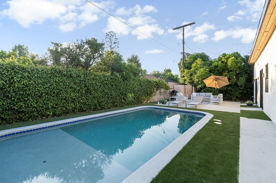 Fenced backyard with pool in quiet residential area