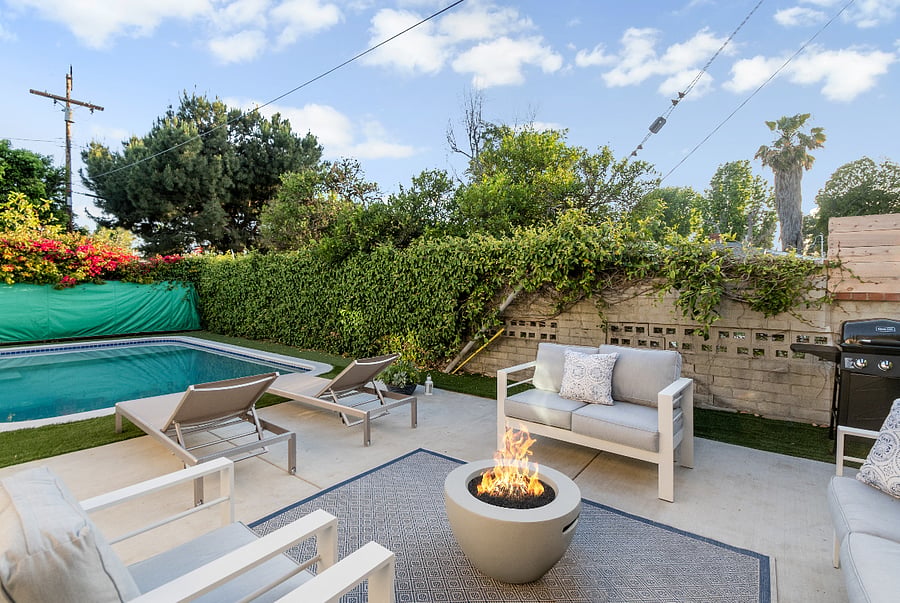 Outdoor lounge with firepit for extended stay relaxation