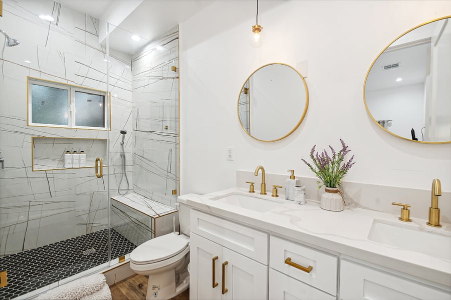 Modern bathroom with walk-in shower and fresh linens