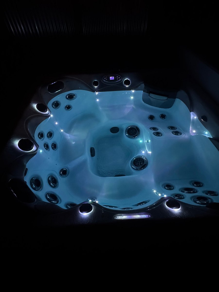 Hot tub with lounger and shoulder massage