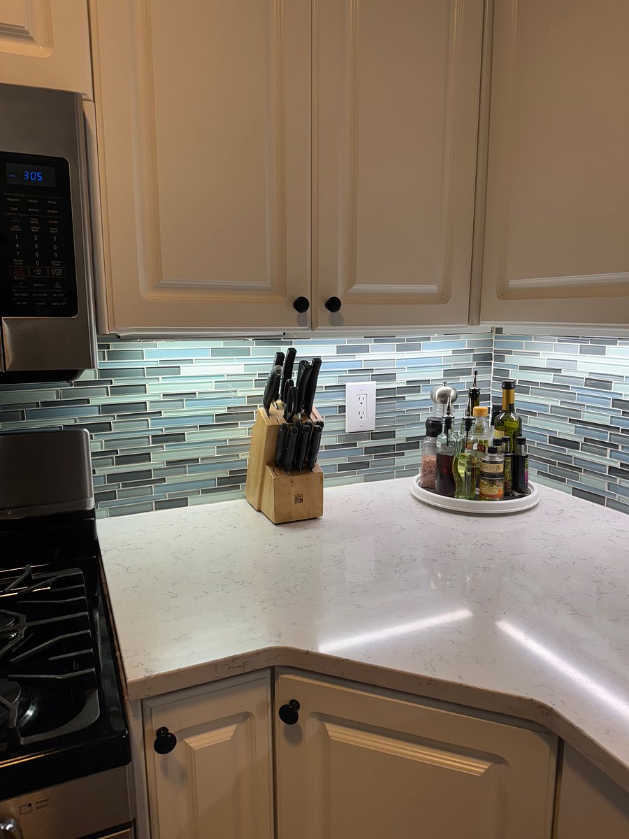 Kitchen with under cabinet lighting and oils for cooking