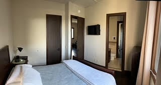 Bedroom 1 with bath and living area access
