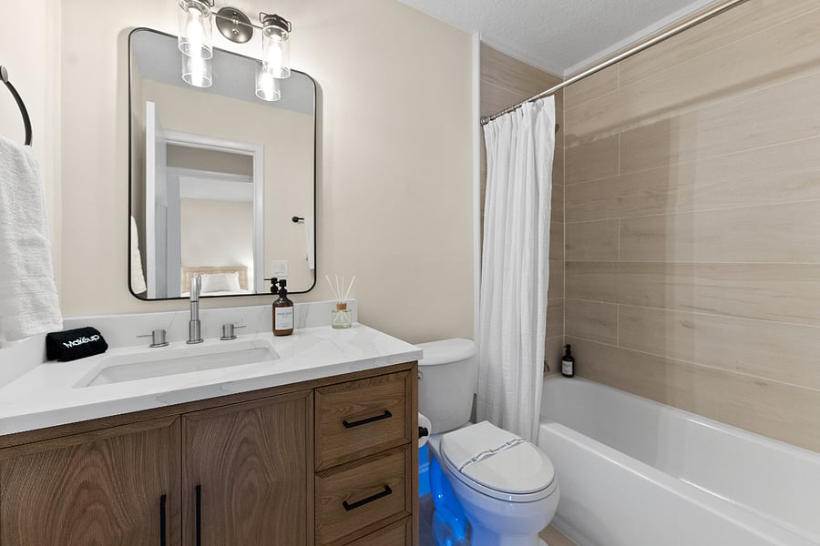 Fully remodeled with brand-new fixtures, this calming guest bath features soft lighting, natural wood tones, and soothing finishescreating a clean, serene space for daily routines, recovery, and quiet moments of self-care.