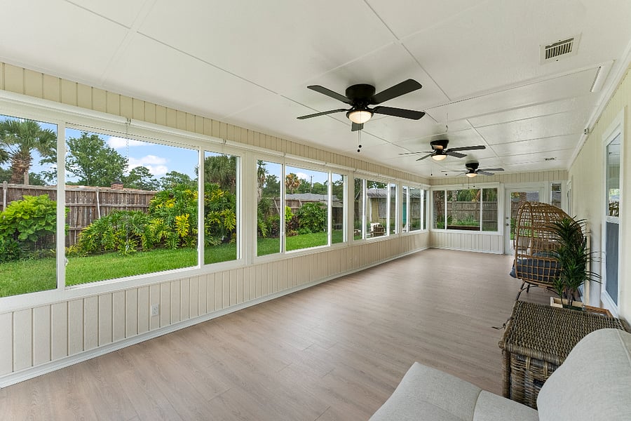 A light-filled sunroom with expansive windows and serene views of the lush backyard. This calming space invites you to unwind, reconnect with nature, enjoy a meal, or book an in-home massageall in peaceful privacy. A true wellness retreat.