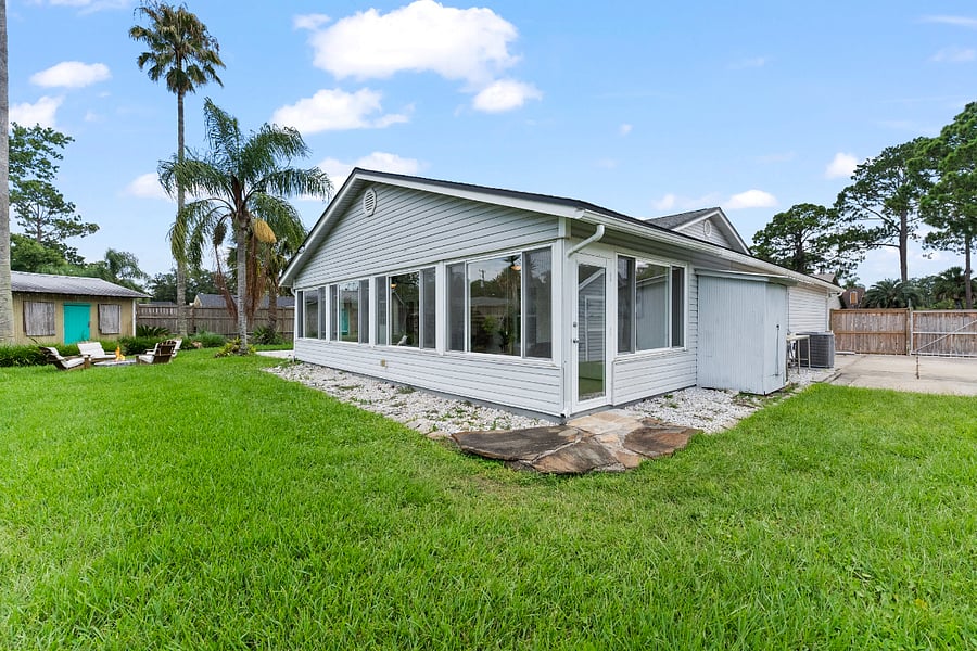 Exterior view of the sunroom highlights the expansive wall of windowsflooding the space with natural light and creating a serene, light-filled environment designed for rest, relaxation, and healing.