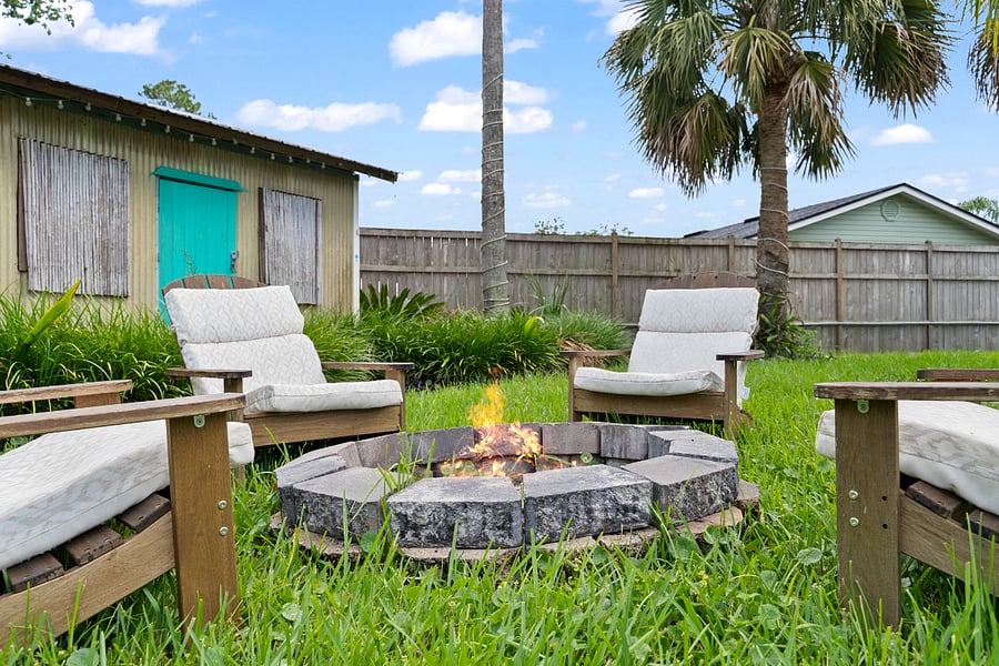 Gather around this beautiful stone firepit, surrounded by cushioned Adirondack chairsperfect for unwinding, sharing stories, and finding peace with loved ones in a calming, natural setting.