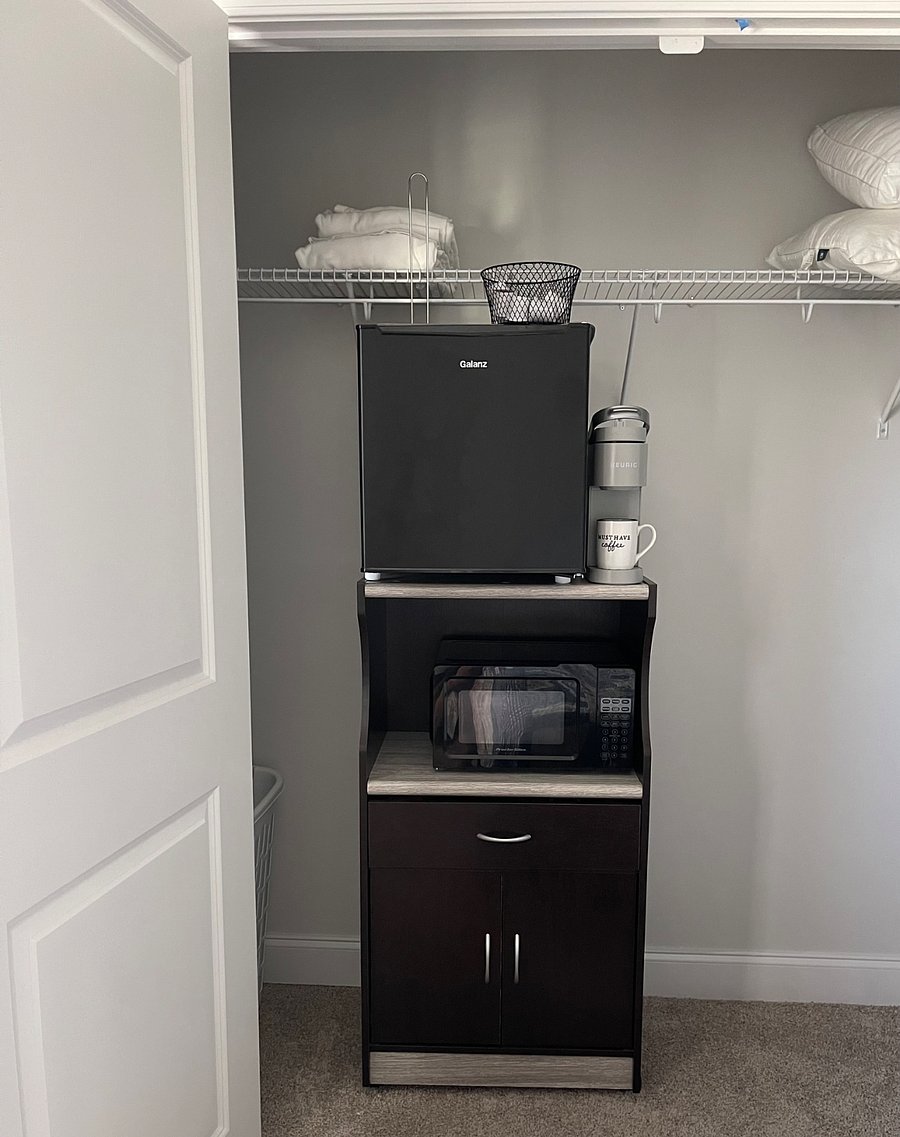 Mini fridge on top, Keurig, and microwave. Drawer has utensils, salt & pepper, sugar, etc.
