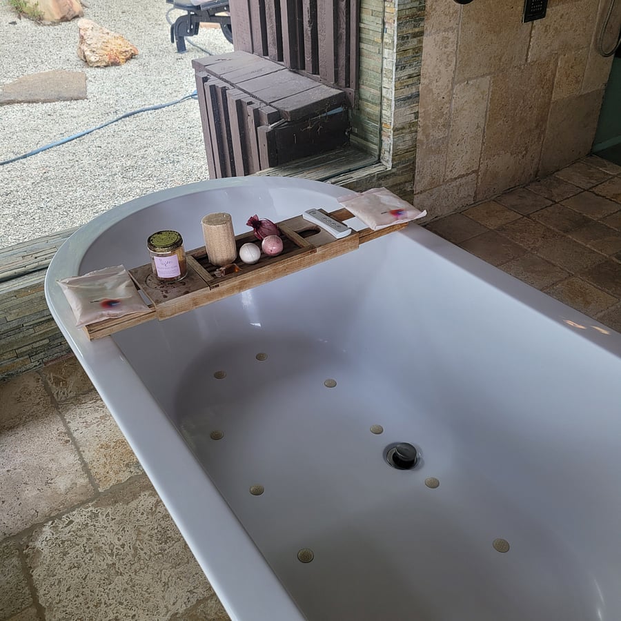 Large soaking tub with remote controlled bubbles.