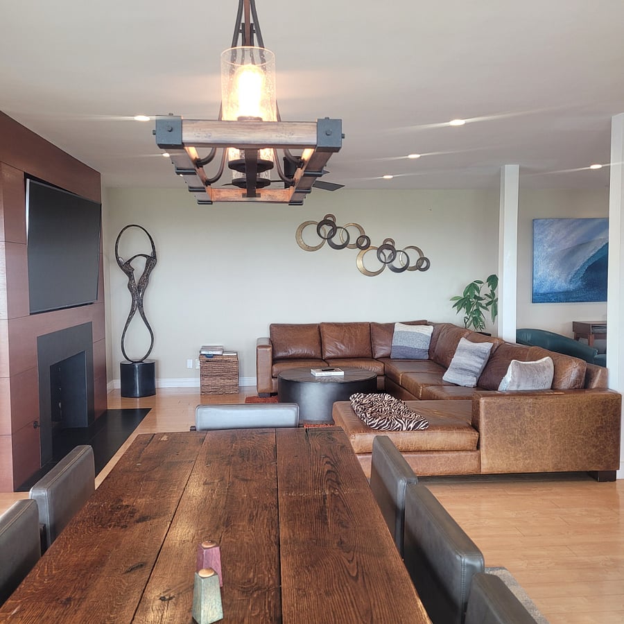 Family room with smart TV, leather couch and modern decor. 