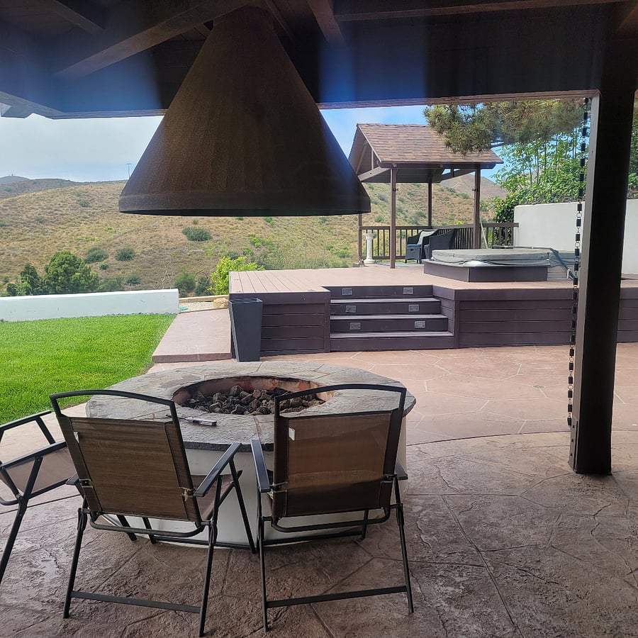 Gas-powered firepit with covered patio.