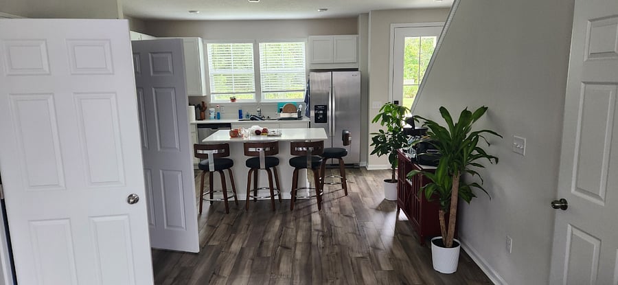 Living room/Kitchen area with 1/2 bath and laundry.