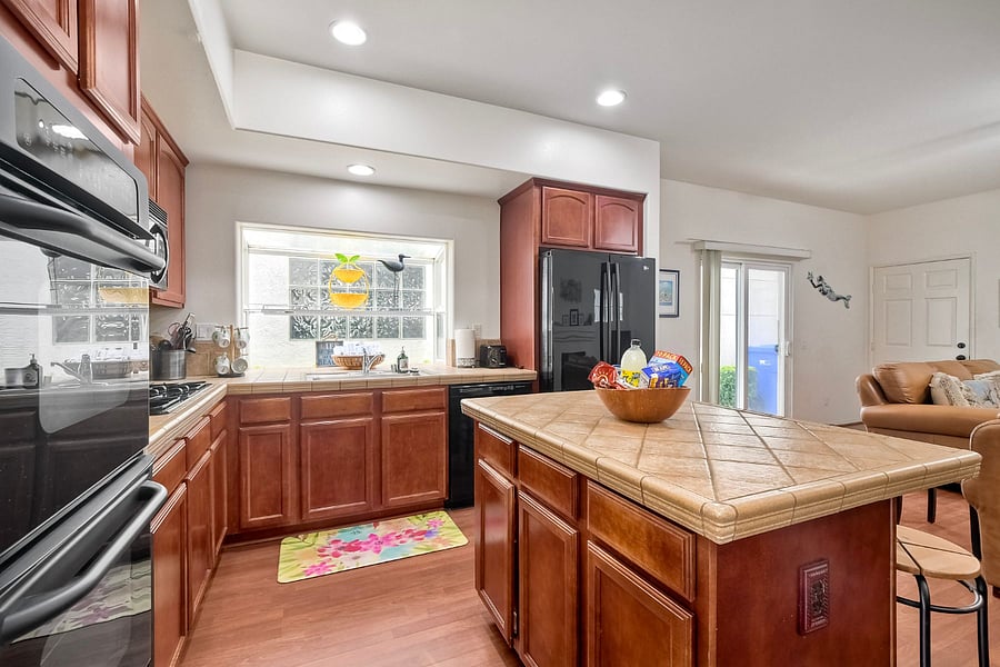 The efficient, well-planned kitchen is fully equipped with dishes, cookware, and all the tools