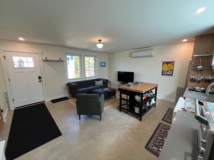 Downstairs living space with seating, eating, and kitchen areas.