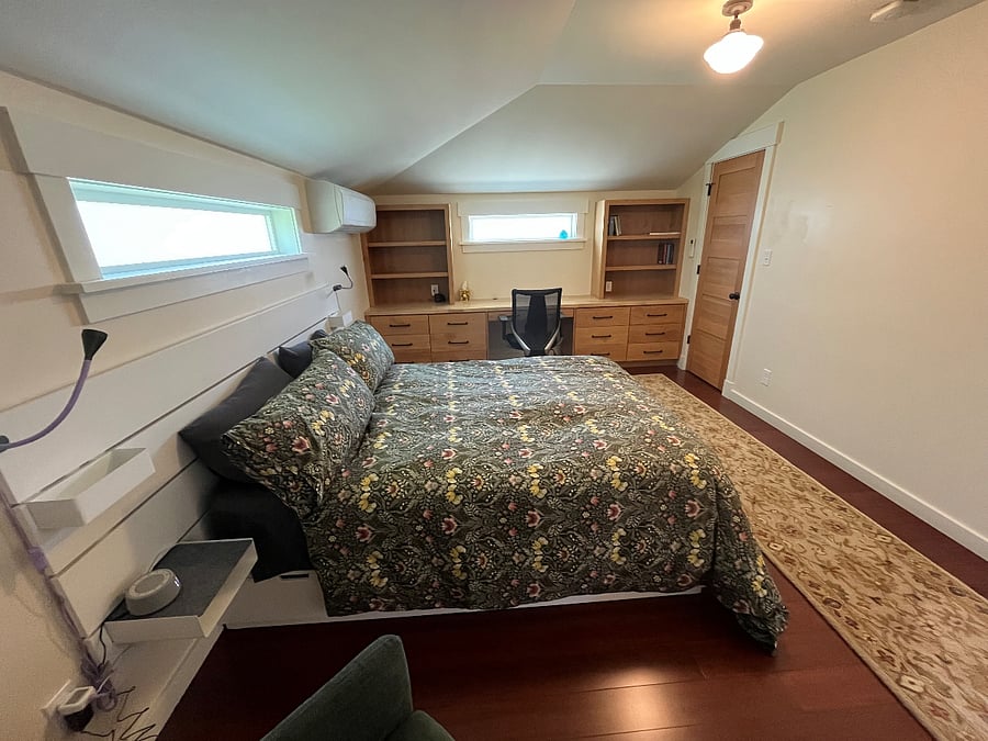 Bedroom (upstairs) with built-in desk, dressers, and bookshelves.