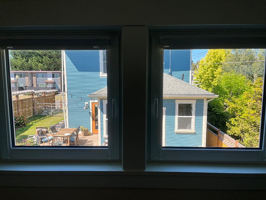View from bedroom facing primary house, up/down room-darkening blinds.