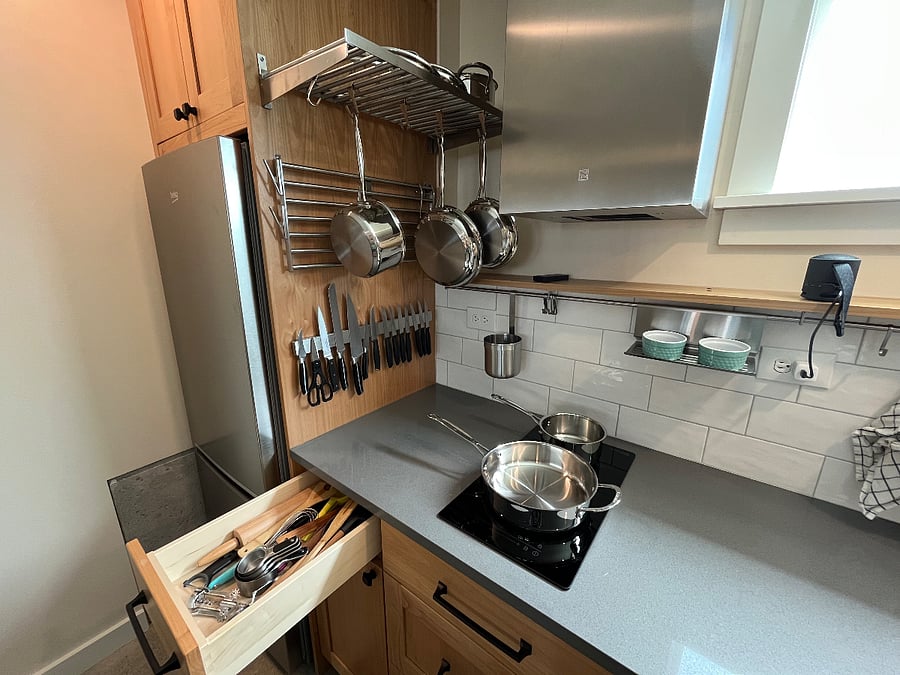 Kitchen with induction burners and vent hood.