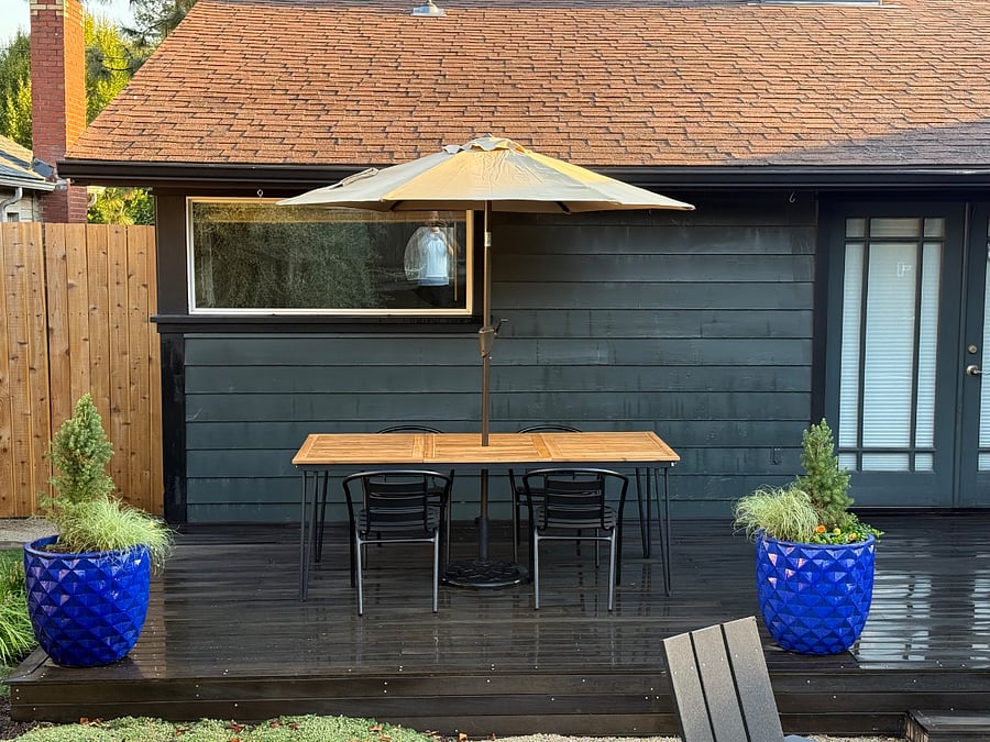 Outdoor patio with dining table, chairs and umbrella