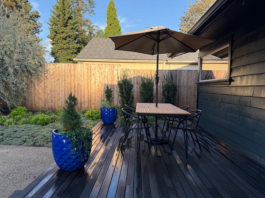 Outdoor patio with dining table, chairs and umbrella