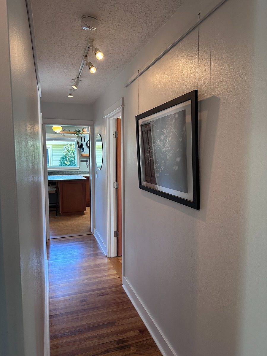 Hallway connecting bedrooms to kitchen