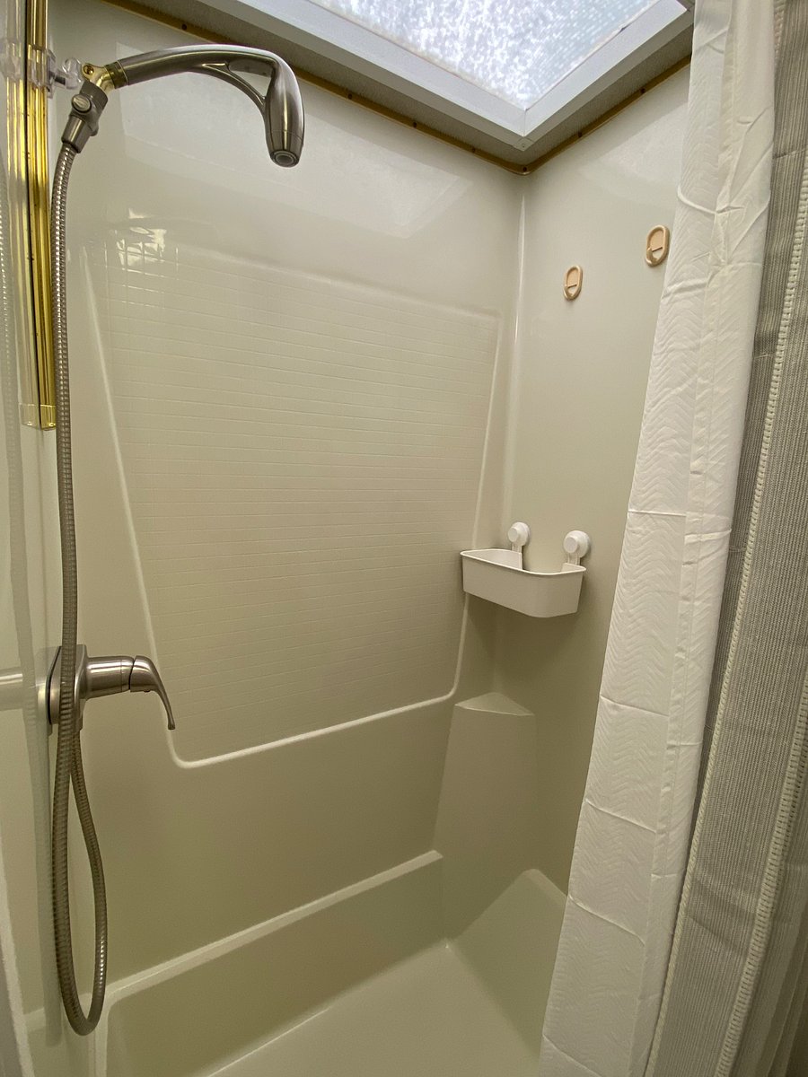 Shower with skylight an extendable curtain rod