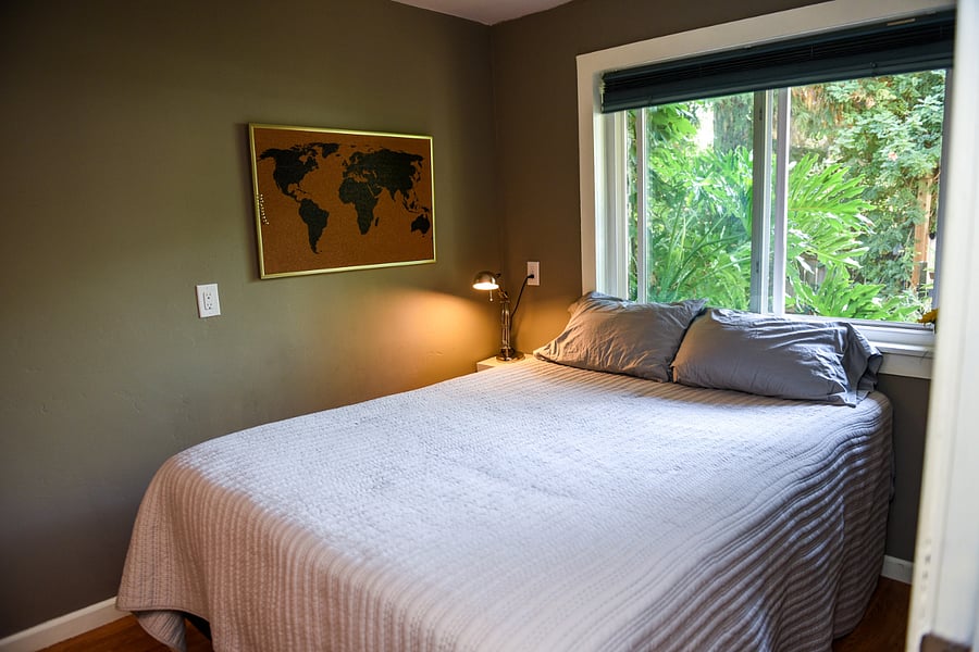 Front bedroom with a queen bed has a window looking over the fountain.