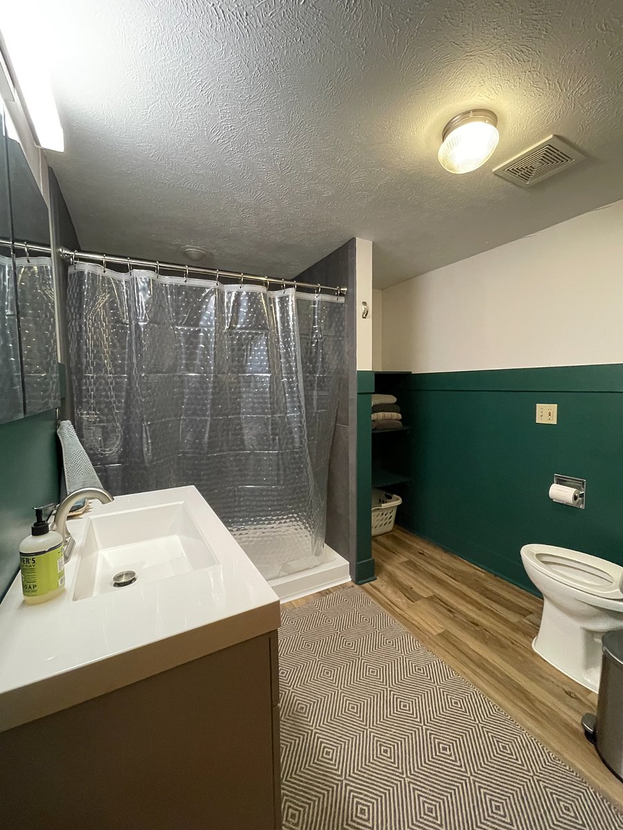 Private basement bathroom with medicine cabinet, shelves, plenty of storage.