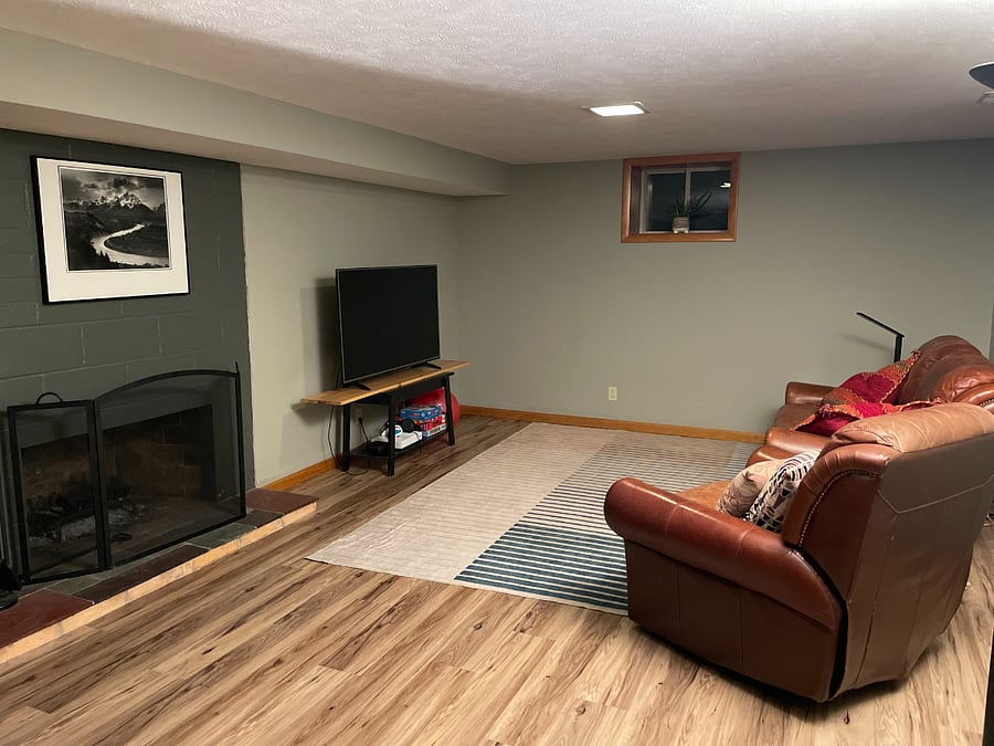 Basement living area, around the corner is an apartment sized refrigerator and microwave for convenience. The upstairs kitchen also has cupboard and refrigerator space as well.
