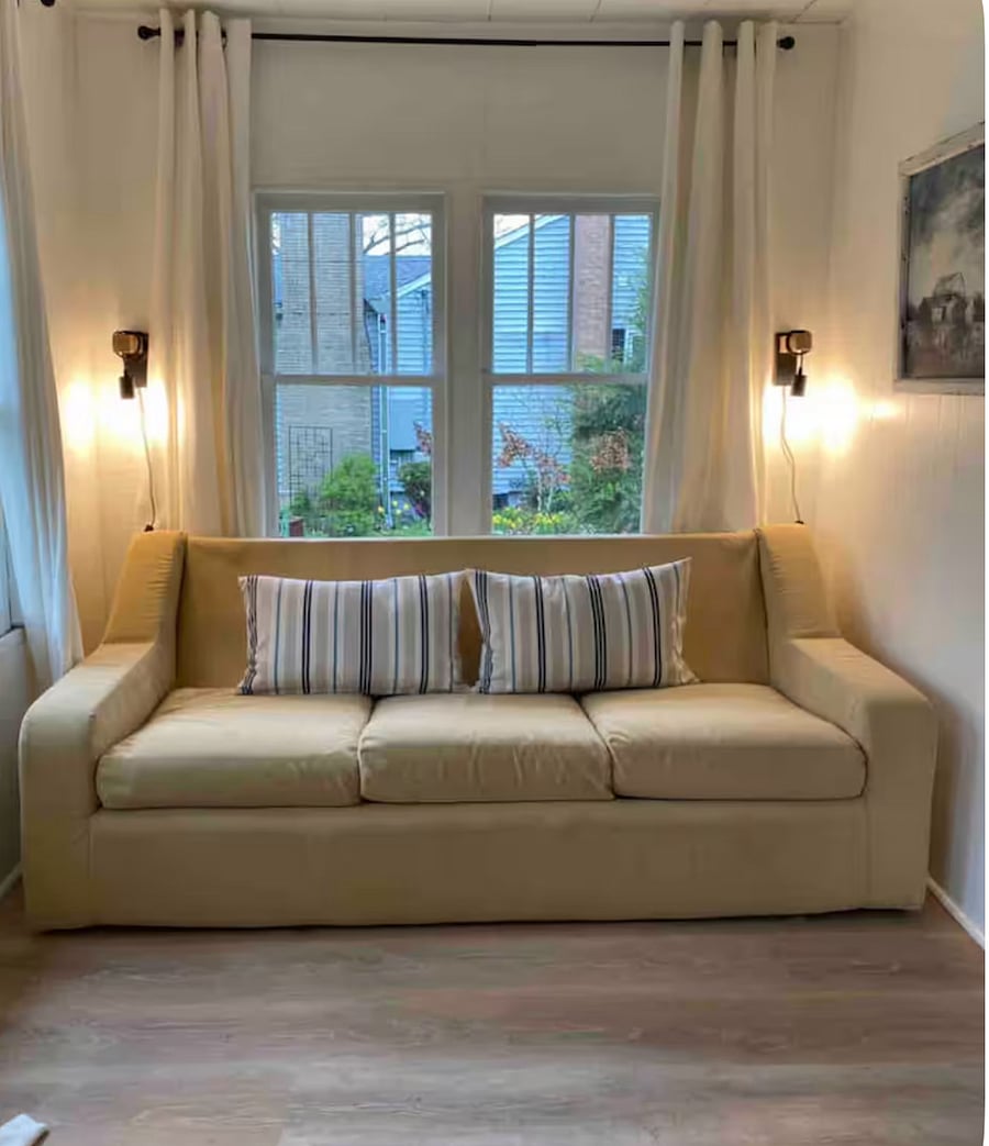 sunroom in the front of the house that includes a sleeper sofa that can be converted into full sized bed
