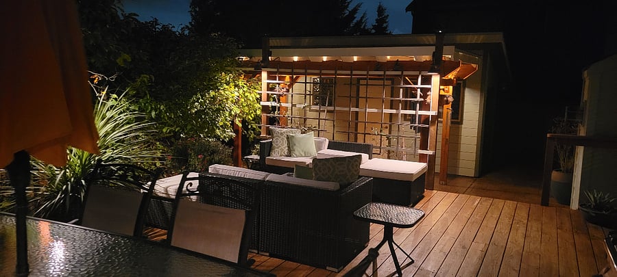 Warm outdoor lighting. Outdoor seating moves under pergola in winter to get out of the rain....