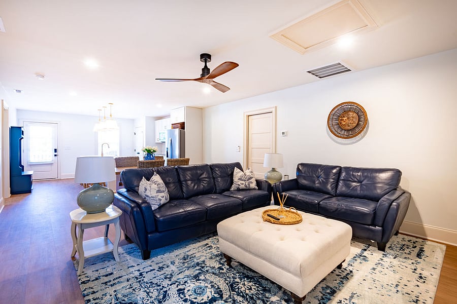 The living room has plenty of seating and a 65" television.