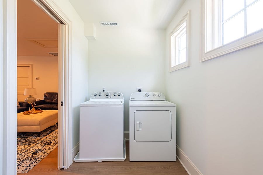 The laundry room is very large with plenty of space for extra storage.