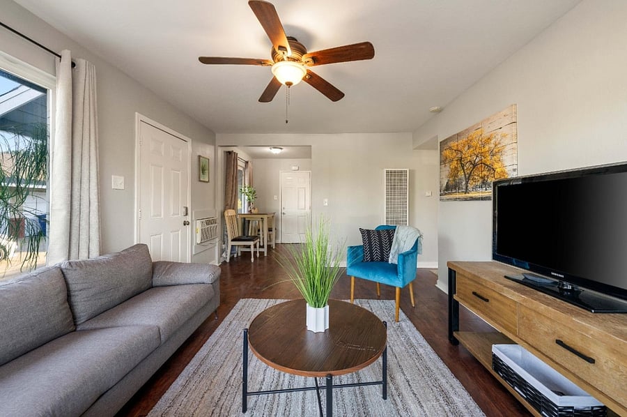 Interior family room with full size loft, central table, side front chair, Wifi Connected TV with XBOX One.
