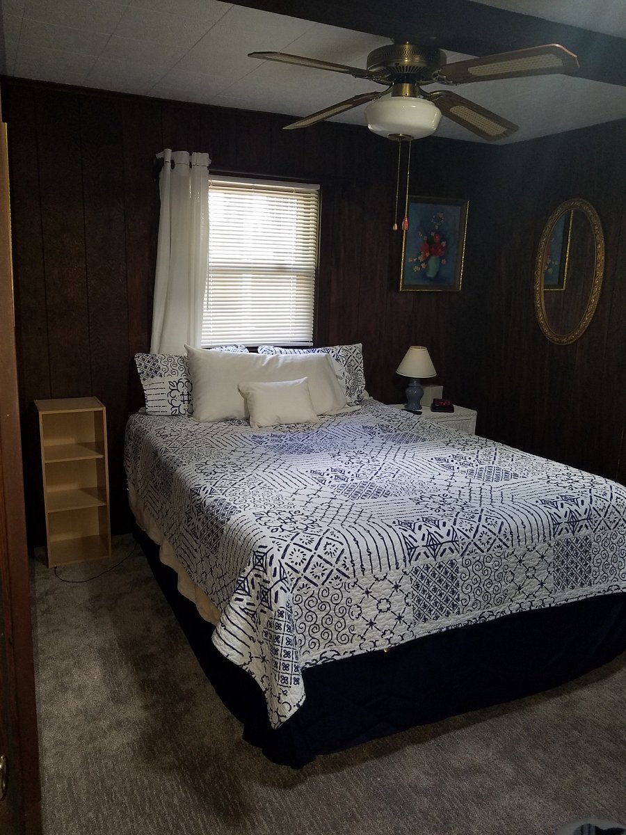 bedroom with queen bed. The bedroom with the twin bunks can be accessed through this room.