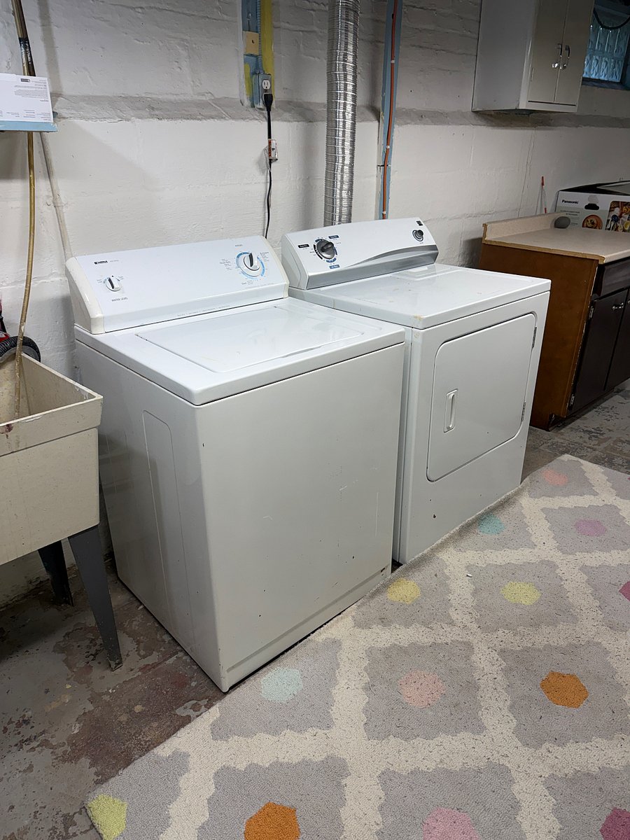 A new washer and dryer (black) has replaced the ones in this picture.