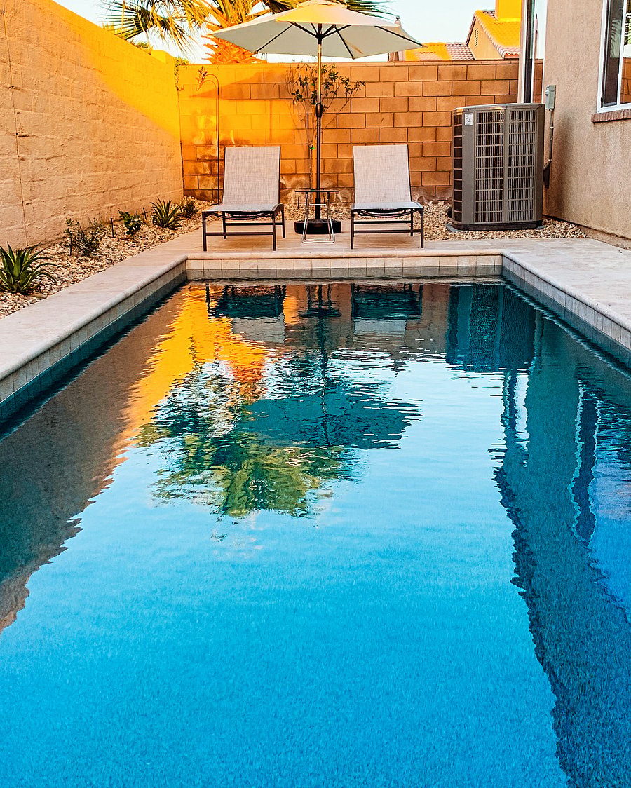 Saltwater pool with lounge chairs and pool floats.