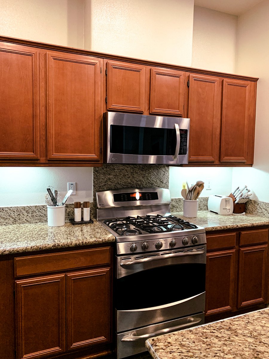 Kitchen with coffee station, full refrigerator, and large pantry.