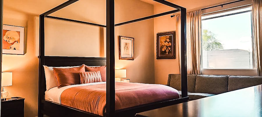 Primary bedroom with ensuite bathroom and queen bed.