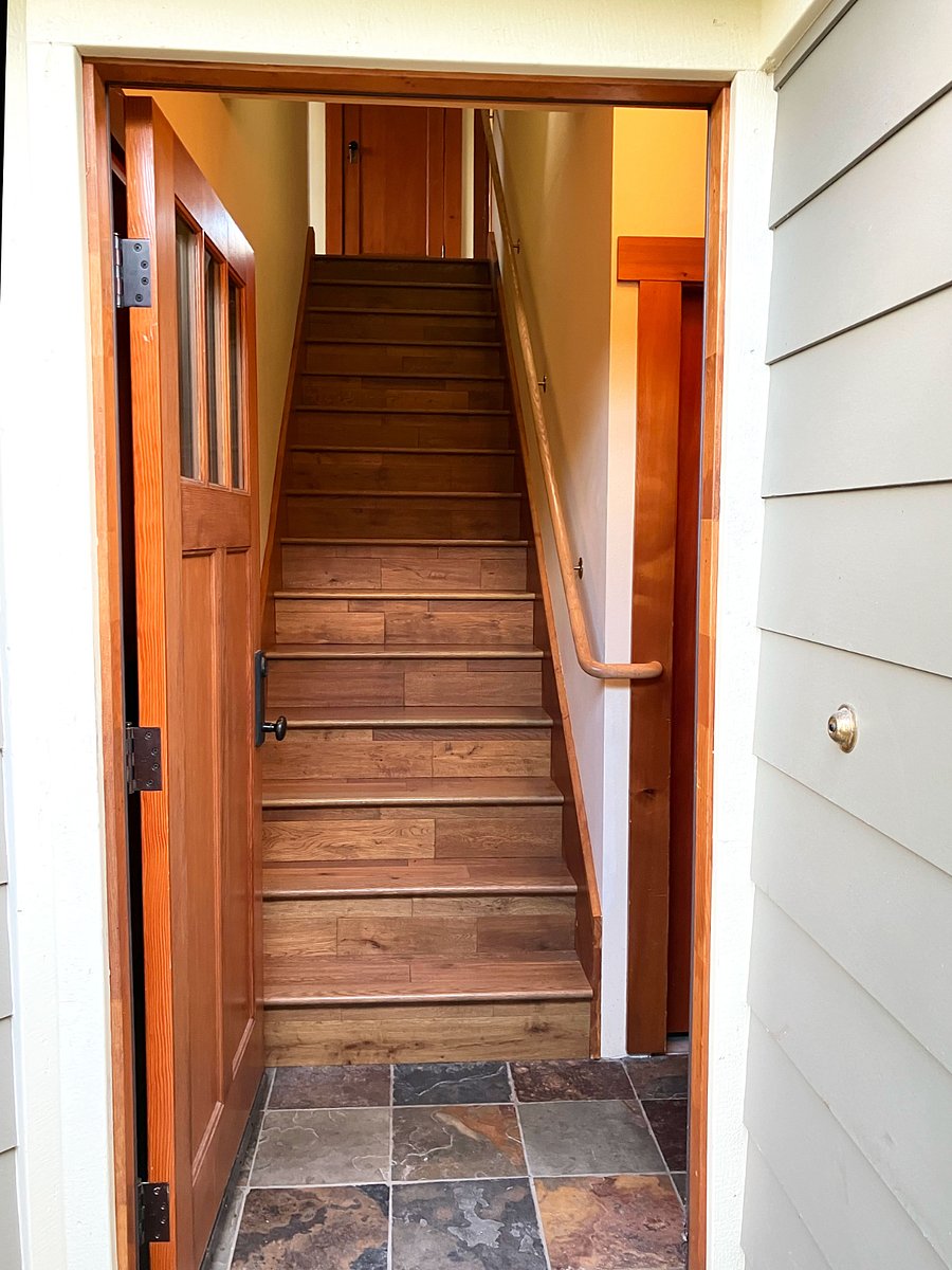 Entryway has alcove with closet. 12 stairs up to the apartment.