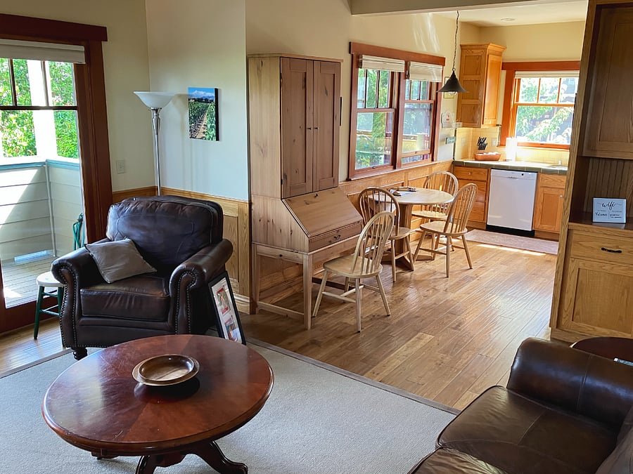 Kitchen off the living room has a well-illuminated, cozy dining space.