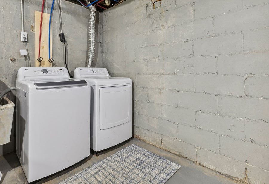 Washer and Dryer in basement area.
