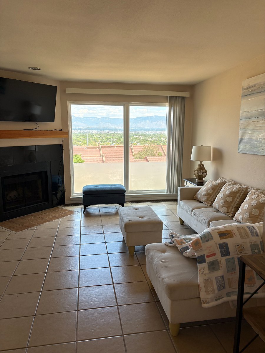 Upstairs open living room area with amazing views to the Sandia Mountains, Rio Grande and city.