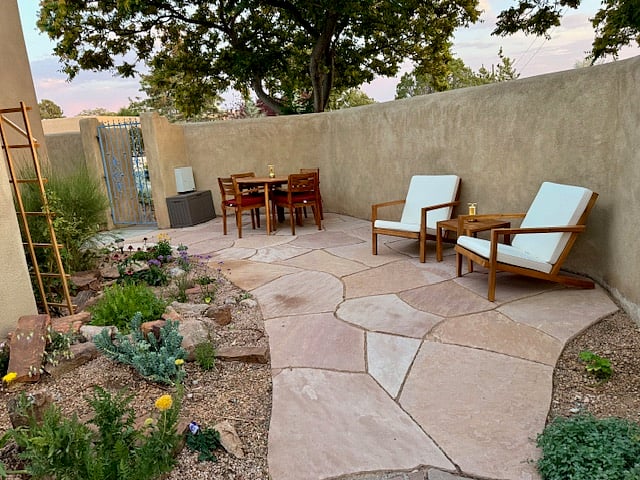 full enclosed property with high adobe wall and gate offers privacy.