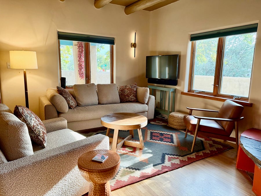 living room features spacious comfortable seating and a fully functioning kiva fireplace.