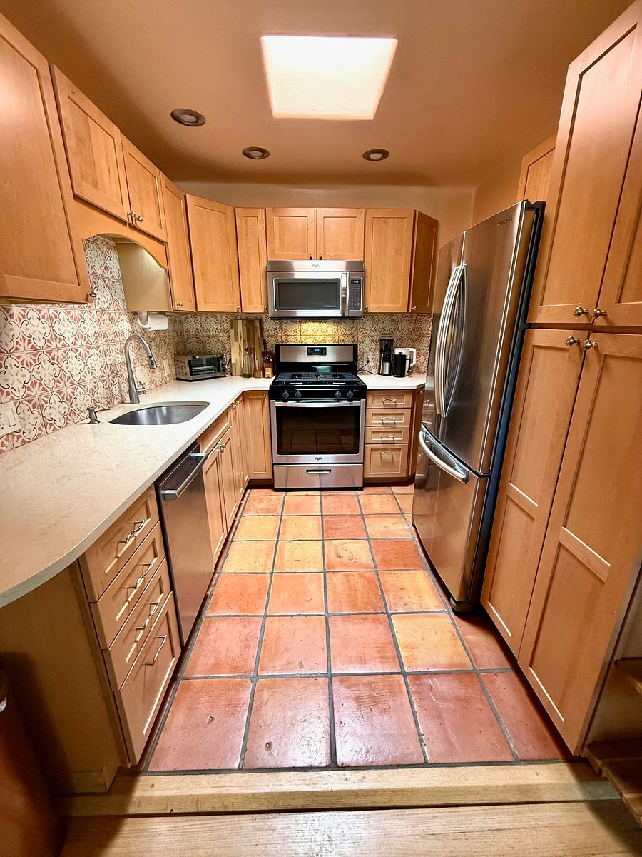 Fully equipped kitchen features a skylight and traditional saltillo tile.