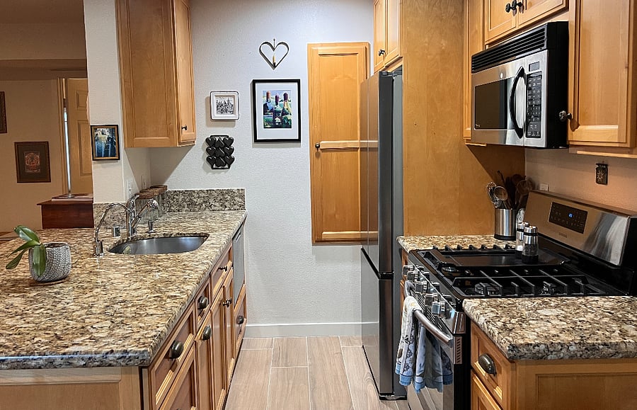 The kitchen is equipped with a garbage disposal, dishwasher drawer, built in trashbin drawer, a new fridge with an automatic ice maker, a microwave, and a gas range with a cooktop and oven. Magic bullet, cuisinar, Blendtec, full set of pots and pans, Makasa dish set, silver-plated flatware, and a drawer of cooking utensils and more. 