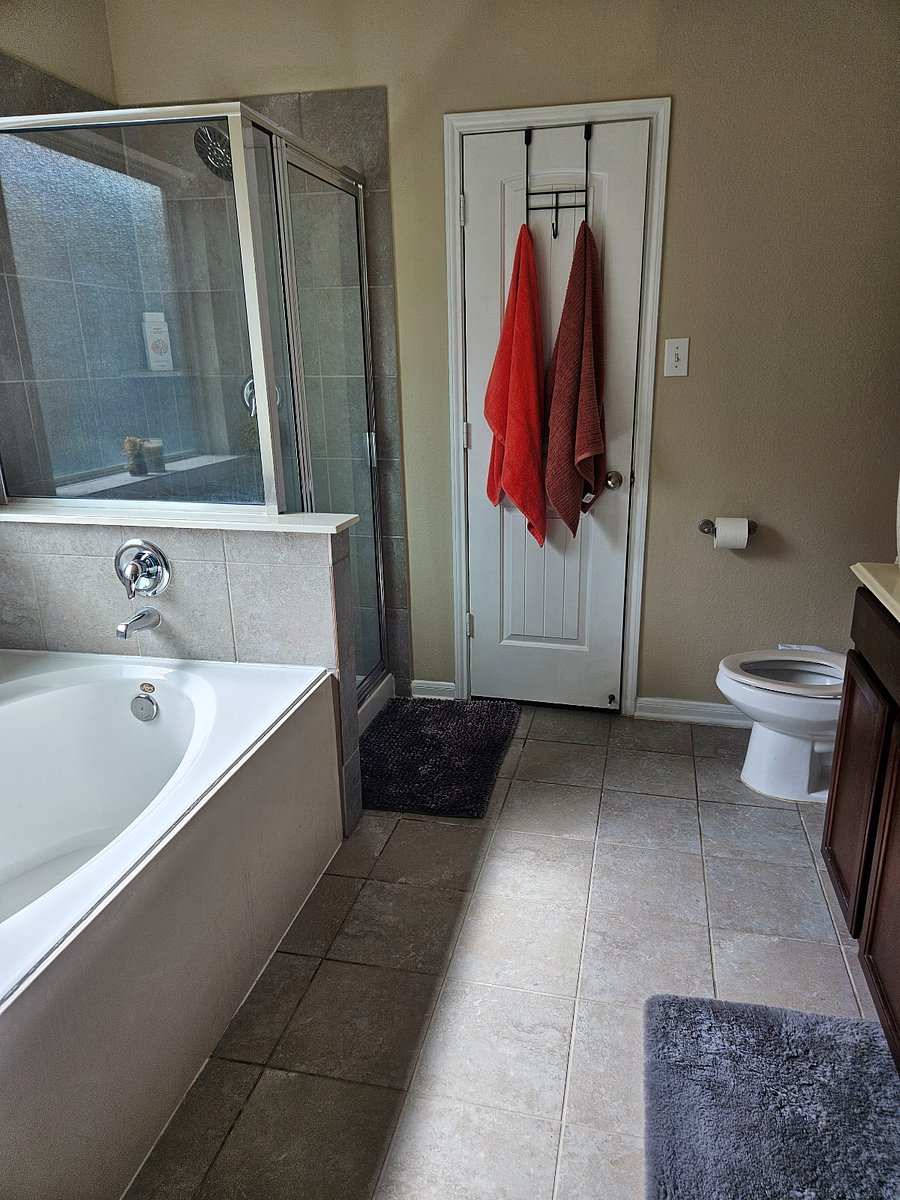 primary bathroom suite with walk-in closet