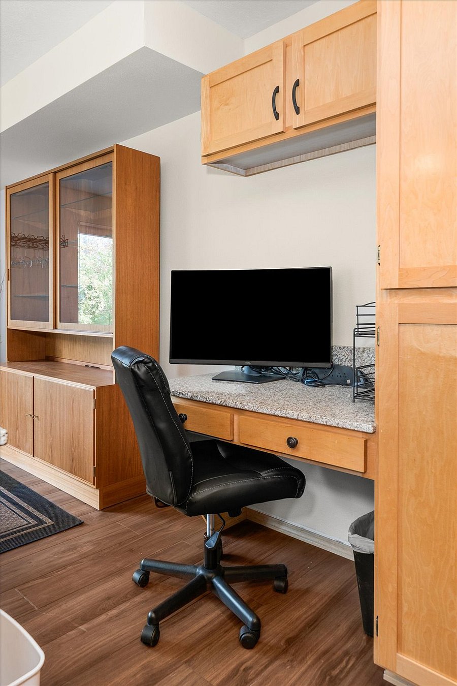 Work desk with large external monitor and cable.